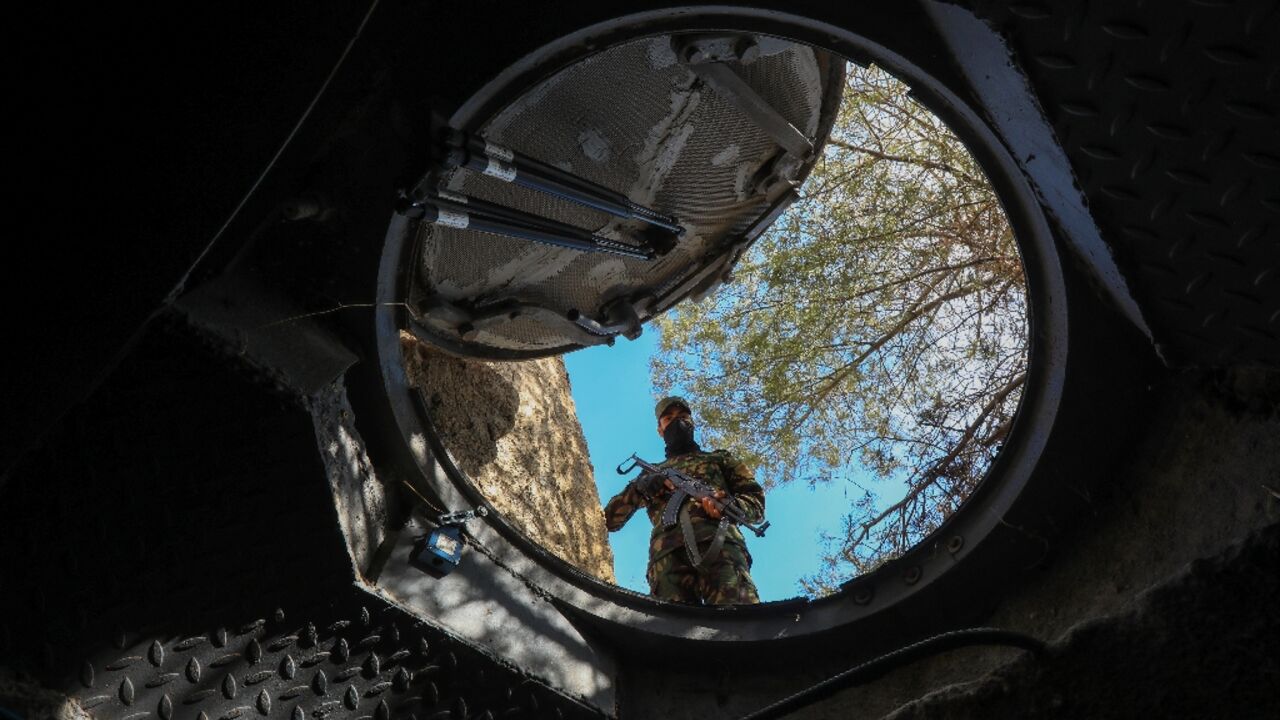 Mountain lair: a soldier looks into a hidden exit from from Maher al-Assad's private office built into a hilltop overlooking Damascus Mountain lair: a soldier looks into a hidden exit from from Maher al-Assad's private office built into a hilltop overlooking Damascus