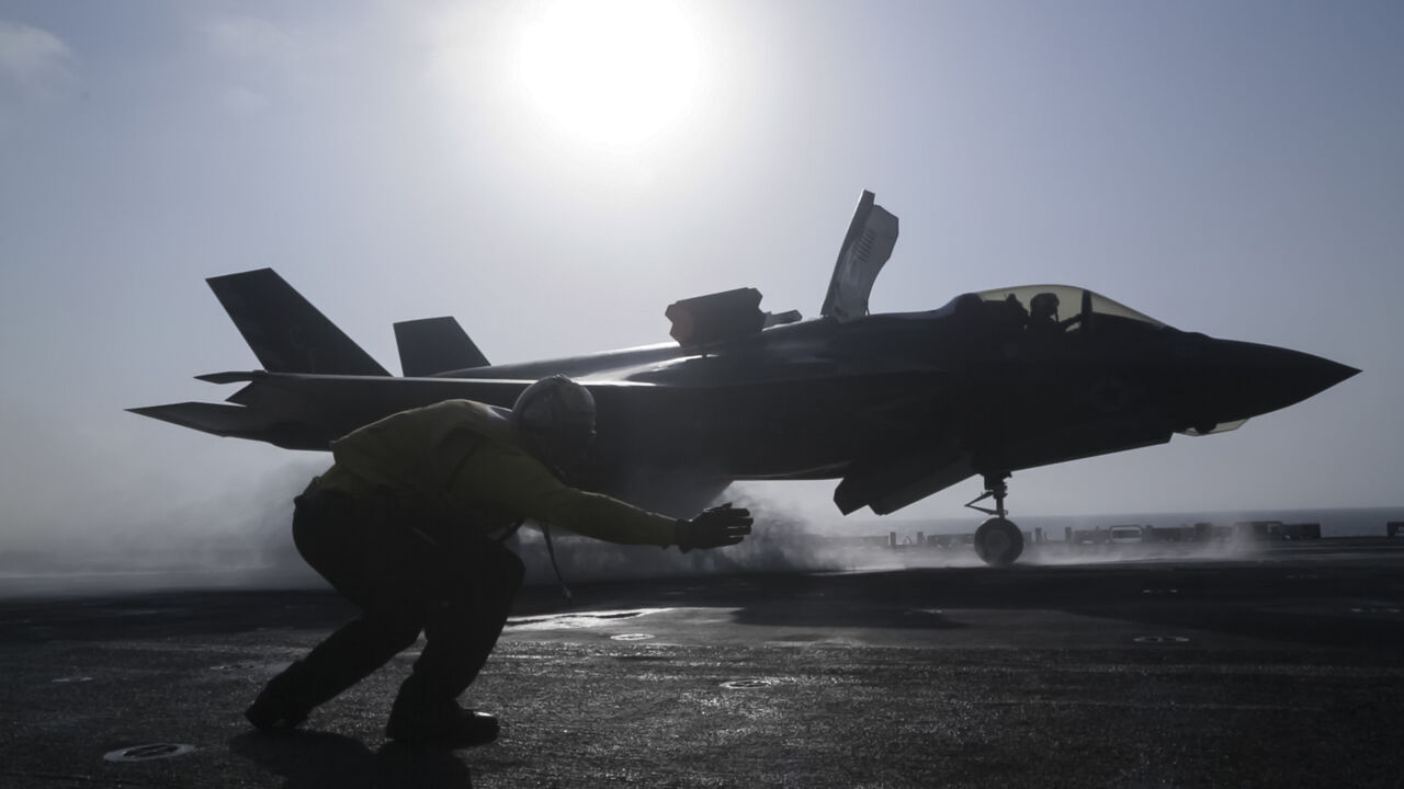 U.S. 5th FLEET AREA OF OPERATIONS (Sept. 27, 2018) U.S. Navy Petty Officer 1st Class Rey White, an aviation boatswains mate handler with the Essex Amphibious Ready Group (ARG), launches an F-35B Lightning II with Marine Fighter Attack Squadron 211, 13th Marine Expeditionary Unit (MEU), from the Wasp-class amphibious assault ship USS Essex (LHD 2), before the F-35B's first combat strike, Sept. 27, 2018. The Essex is the flagship for the Essex Amphibious Ready Group and, with the embarked 13th MEU, is deploye