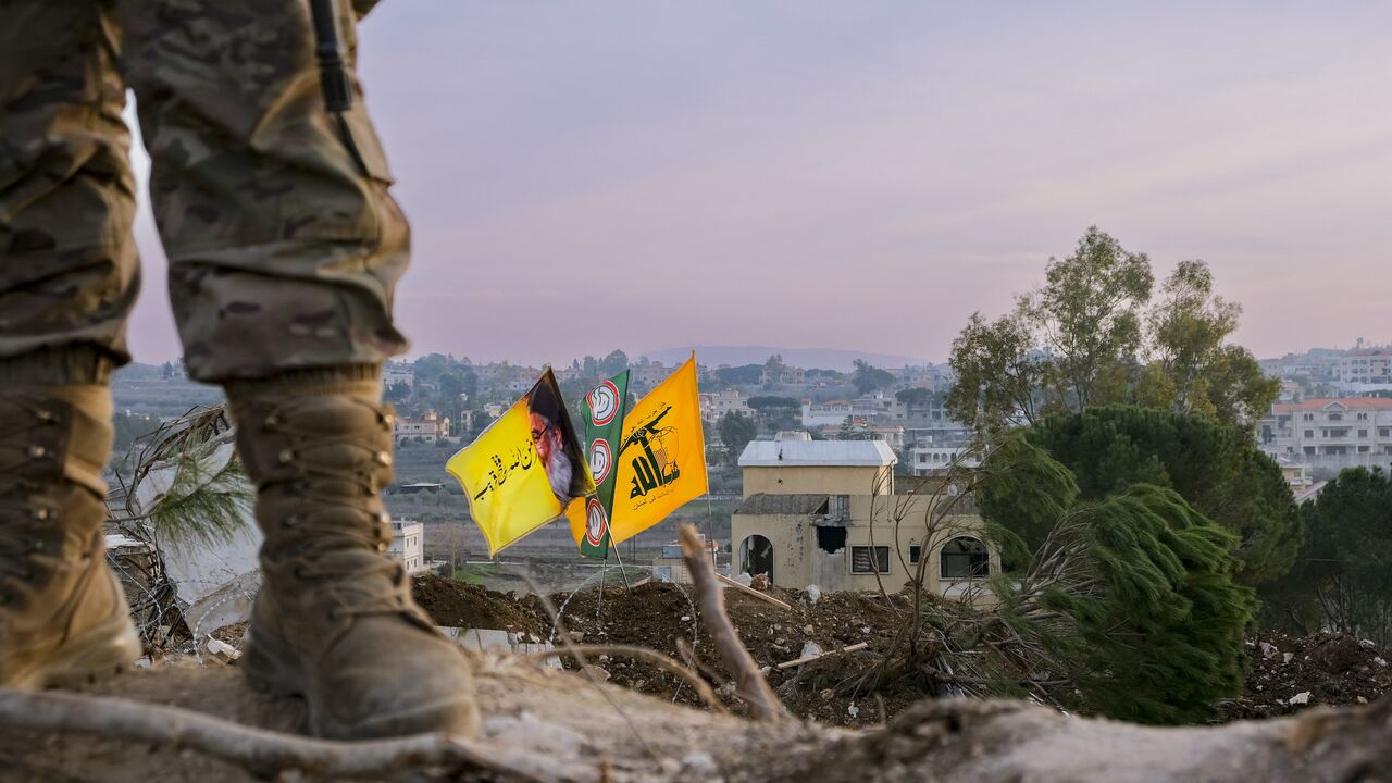 Lebanese army soldiers stand on an earthen barrier constructed by Israeli forces in the town of Yaroun, Lebanon, on Feb. 2, 2025.
