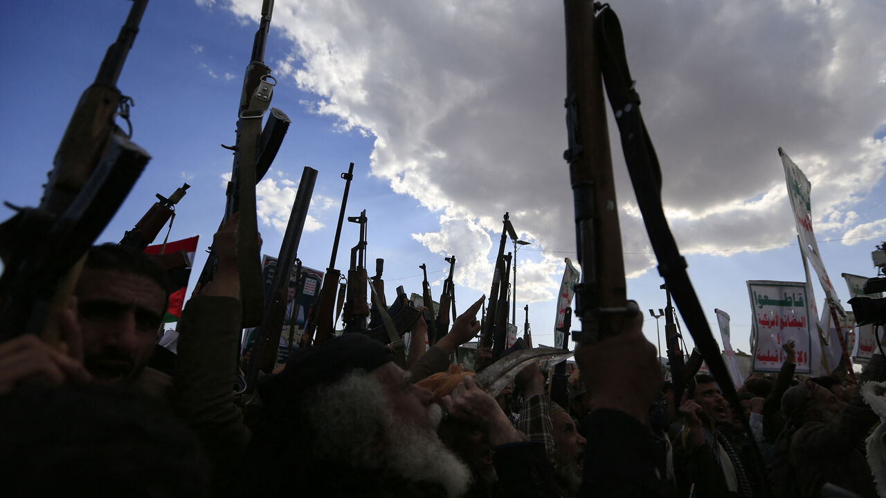 Yemenis brandish rifles and chant during a demonstration called for by the rebel Huthi movement in Sanaa on March 17, 2025. Huge crowds joined protests in rebel-controlled Yemen on March 17 after deadly US strikes killed dozens and sparked fears of a new cycle of violence in the conflict-torn country. (Photo by Mohammed HUWAIS / AFP) (Photo by MOHAMMED HUWAIS/AFP via Getty Images)