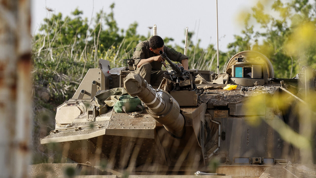 An Israeli soldier checks a Merkava battle tank deployed at a position in the Israel-annexed Golan Heights along the border with southern Syria on March 25, 2025. Israel's military said it carried out a second strike in Syria on March 25, in response to incoming fire from across the demarcation line, hours after Syrian authorities reported that at least five people had been killed as a result of Israeli shelling. (Photo by Jalaa MAREY / AFP) (Photo by JALAA MAREY/AFP via Getty Images)