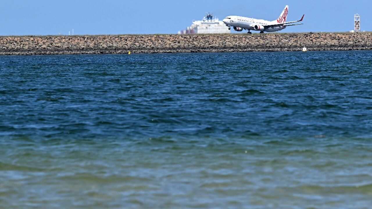 A Virgin Australia plane touches down at Sydney International Airport on February 27. Australia will let Qatar Airways buy a 25 percent stake in troubled Virgin Australia A Virgin Australia plane touches down at Sydney International Airport on February 27. Australia will let Qatar Airways buy a 25 percent stake in troubled Virgin Australia