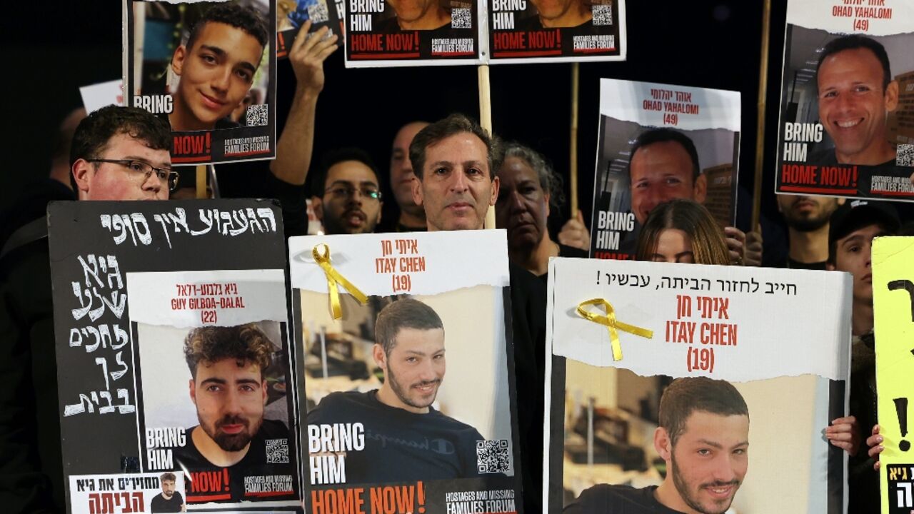 Relatives and supporters hold portraits of Israeli hostages, including Guy Gilboa-Dalal, pictured bottom left Relatives and supporters hold portraits of Israeli hostages, including Guy Gilboa-Dalal, pictured bottom left