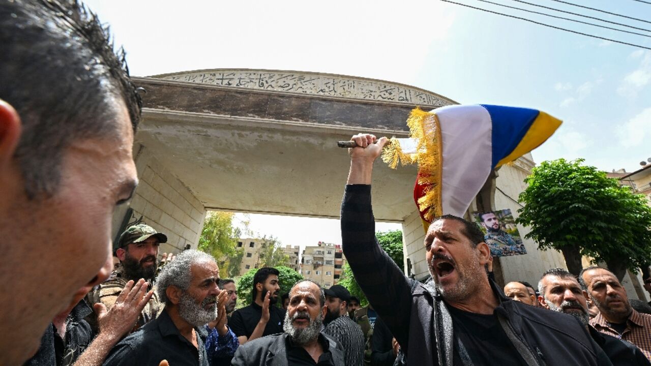 Members of Syria's Druze community wave flags and chant slogans during the funeral of people killed during clashes with Syrian security forces on April 30, 2025 Members of Syria's Druze community wave flags and chant slogans during the funeral of people killed during clashes with Syrian security forces on April 30, 2025