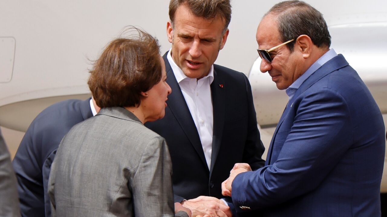 Egypt's President Abdel Fattah al-Sisi (R) and French President Emmanuel Macron (C) arriving in El-Arish Egypt's President Abdel Fattah al-Sisi (R) and French President Emmanuel Macron (C) arriving in El-Arish