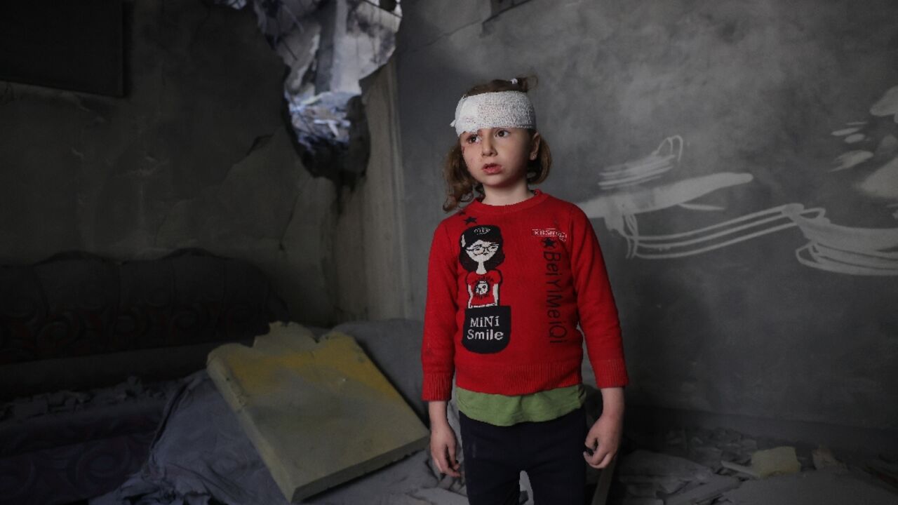 A wounded Palestinian girl stands amid the debris of her family home after overnight Israeli strikes A wounded Palestinian girl stands amid the debris of her family home after overnight Israeli strikes