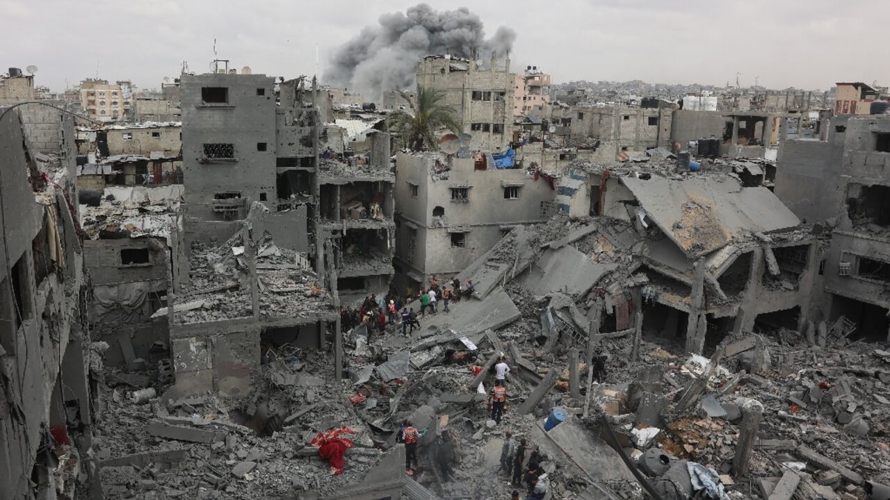 Palestinian rescuers search the rubble of a four-storey residential block in Gaza City for survivors after it was flattened by an Israeli strike, killing at least 23 people, according to the civil defence agency. Palestinian rescuers search the rubble of a four-storey residential block in Gaza City for survivors after it was flattened by an Israeli strike, killing at least 23 people, according to the civil defence agency.