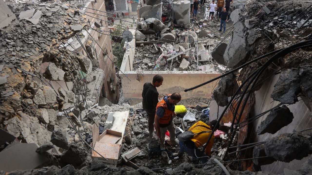 Palestinian medics search the rubble following Israeli strikes in Gaza City Palestinian medics search the rubble following Israeli strikes in Gaza City
