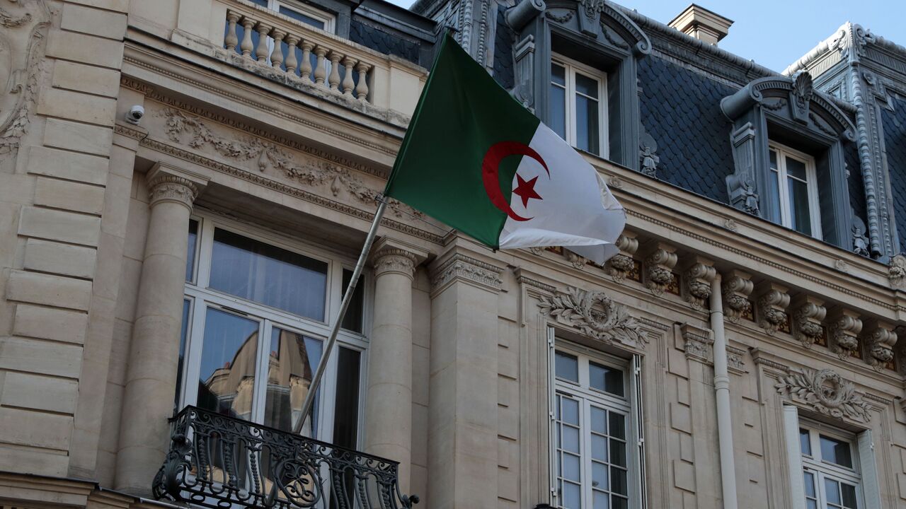 A picture taken on July 23, 2021 shows an Algerian flag fluttering on the facade of the embassy in Paris. - Algeria expressed "deep concern" following press reports that it may have been the target of the Israeli-made Pegasus spyware as it launched a probe. (Photo by Joël SAGET / AFP) (Photo by JOEL SAGET/AFP via Getty Images)