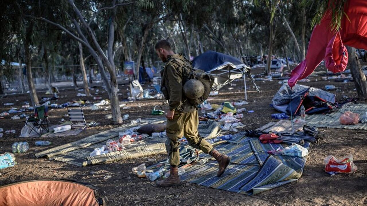 An Israeli soldier patrols near Kibbutz Reim, close to the place where 270 revelers were killed by militants during the Supernova Oct. 7 music festival, in southern Israel, Oct. 12, 2023.