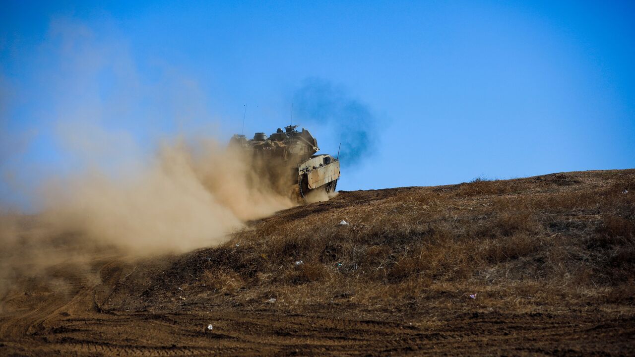 An Israeli military tank moves to a position during a drill in the annexed Golan Heights on November 9, 2023, amid increasing cross-border tensions between Hezbollah and Israel as fighting continues in the south with Hamas militants in the Gaza Strip. (Photo by Jalaa MAREY / AFP) (Photo by JALAA MAREY/AFP via Getty Images)