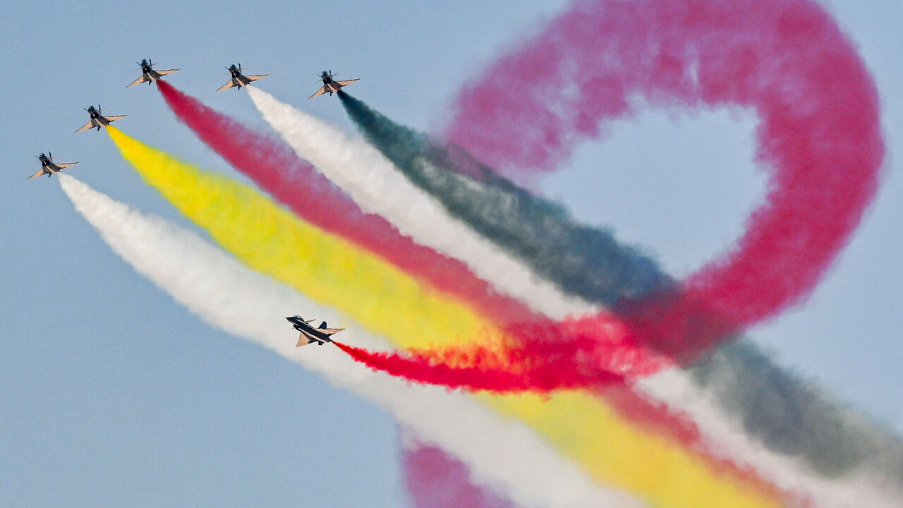TOPSHOT - Chengdu J-10 Vigorous Dragon fighter aircraft of China's Ba Yi (August 1st) Aerobatics Team release smoke while performing manoeuvres during the first Egypt International Airshow at Alamein International Airport in Alamein in northern Egypt on September 4, 2024. (Photo by Khaled DESOUKI / AFP) (Photo by KHALED DESOUKI/AFP via Getty Images)
