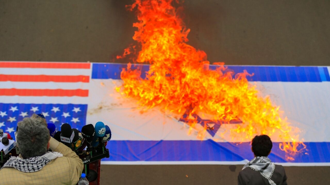 Demonstrators burn US and Israeli flags during a Sanaa rally in solidarity with Palestinians in the Gaza Strip Demonstrators burn US and Israeli flags during a Sanaa rally in solidarity with Palestinians in the Gaza Strip