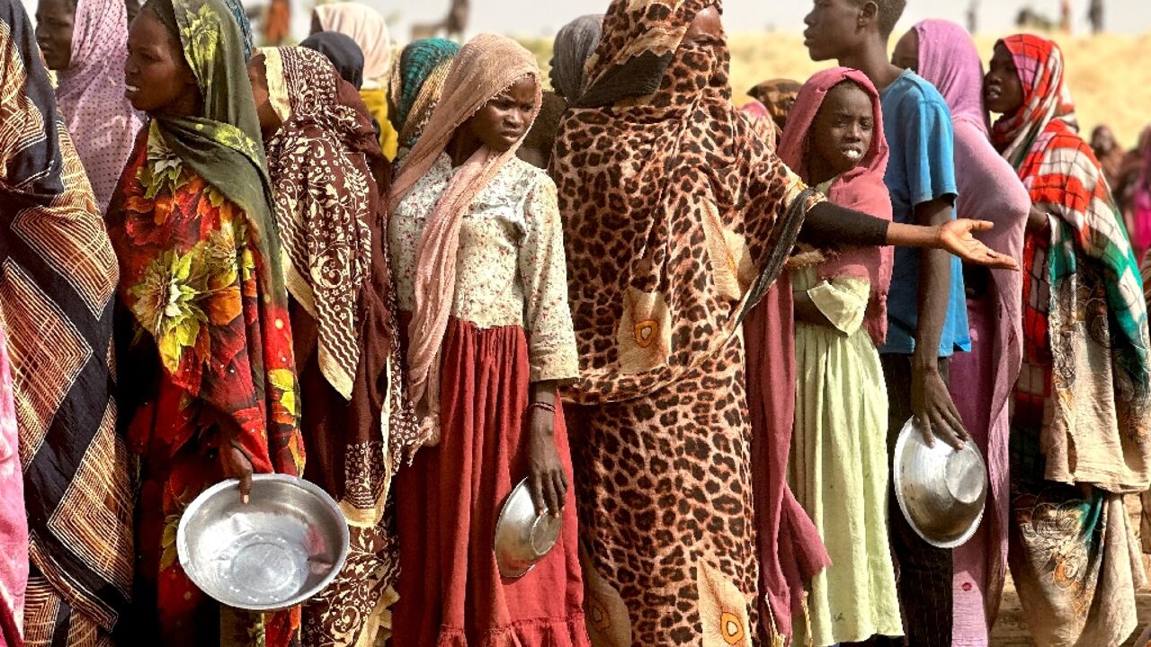 Sudanese who fled the Zamzam camp for the internally displaced after it fell under paramilitary control, queue for food rations in a makeshift encampment in an open field near the town of Tawila Sudanese who fled the Zamzam camp for the internally displaced after it fell under paramilitary control, queue for food rations in a makeshift encampment in an open field near the town of Tawila