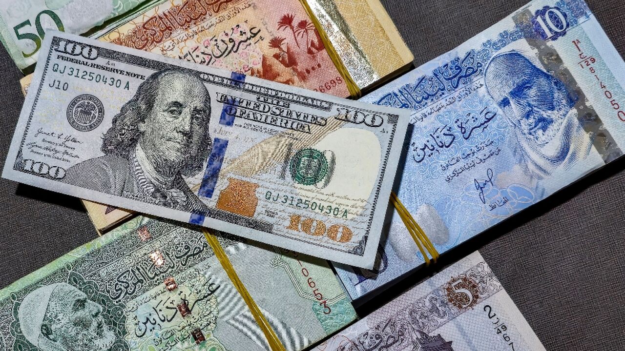 The Libyan central bank earlier this month devalued the dinar by 13.3 percent, the second such move in five years The Libyan central bank earlier this month devalued the dinar by 13.3 percent, the second such move in five years