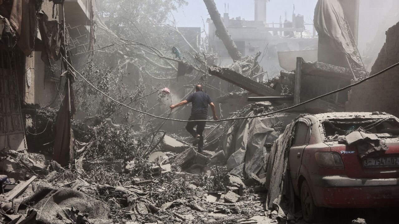 A Palestinian man inspects the rubble following Israeli strikes on a home in Tuffah neighbourhood of Gaza City A Palestinian man inspects the rubble following Israeli strikes on a home in Tuffah neighbourhood of Gaza City