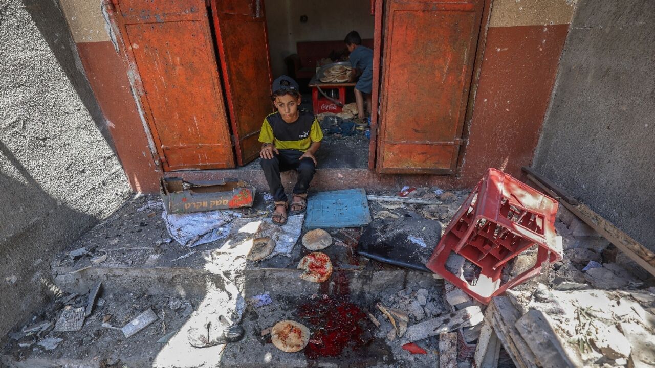 Palestinian boys salvage bread from a makeshift bakery hit in Israeli strikes in the central Gaza Strip Palestinian boys salvage bread from a makeshift bakery hit in Israeli strikes in the central Gaza Strip
