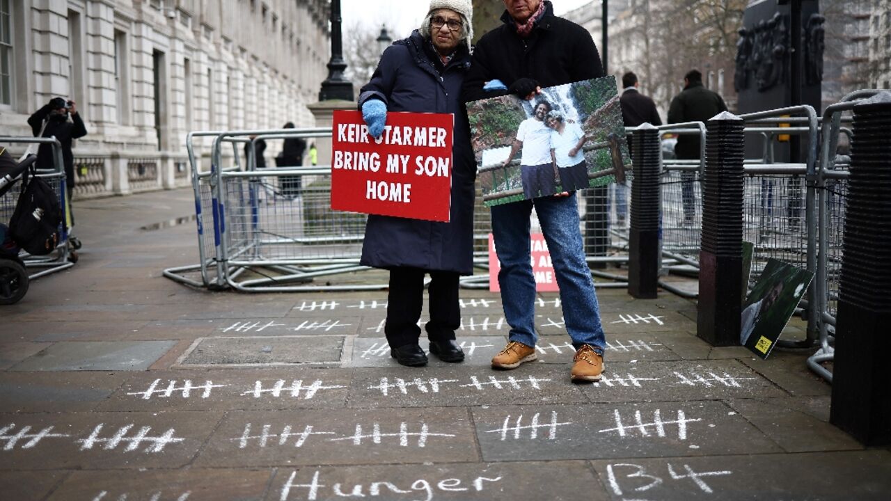 Fattah's mother Soueif (L) holds a placard reading 'Keir Starmer, bring my son home' Fattah's mother Soueif (L) holds a placard reading 'Keir Starmer, bring my son home'