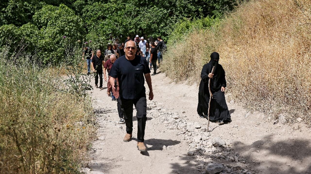 Arab Israelis walk through the overgrown ruins of the Palestinian village of Al-Lajjun, deserted since 1948, to commemorate the "catastrophe" of Israel's creation. Arab Israelis walk through the overgrown ruins of the Palestinian village of Al-Lajjun, deserted since 1948, to commemorate the "catastrophe" of Israel's creation.