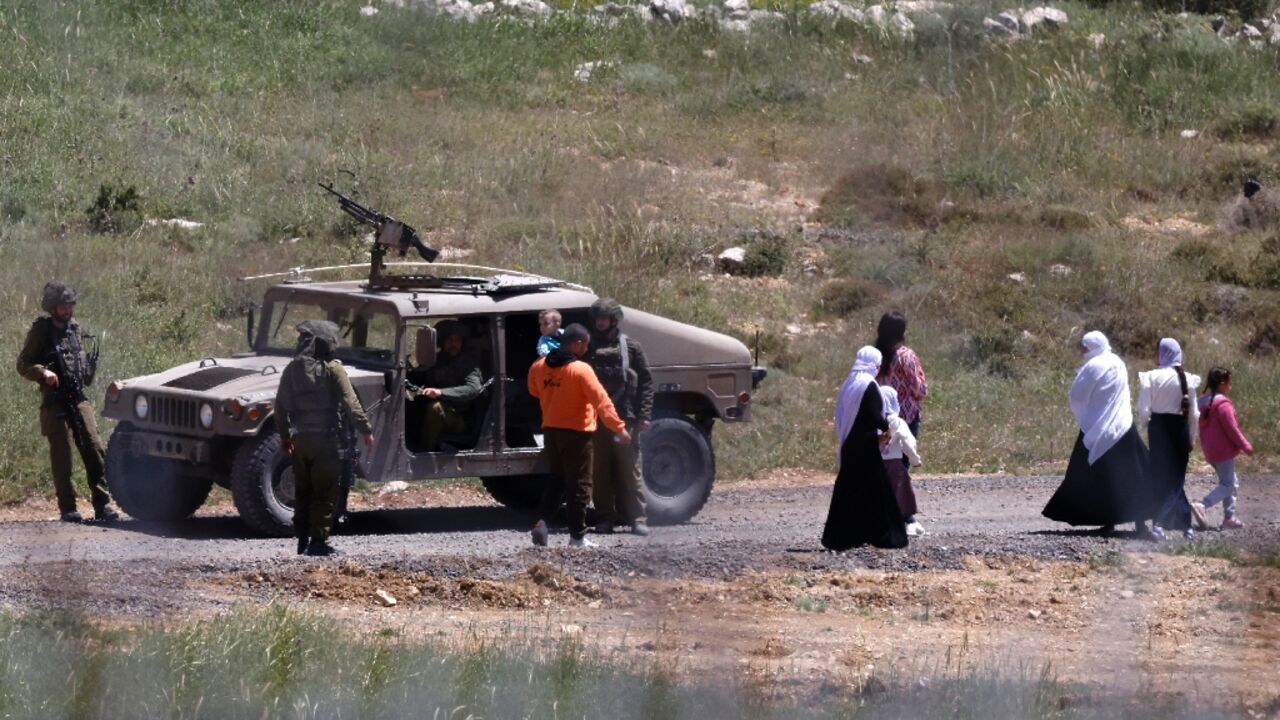 Israeli soldiers stop a Syrian Druze family, who fled sectarian violence outside Damascus, from crossing the buffer zone that used to separate Israeli and Syrian forces on Golan Heights. Israeli soldiers stop a Syrian Druze family, who fled sectarian violence outside Damascus, from crossing the buffer zone that used to separate Israeli and Syrian forces on Golan Heights.
