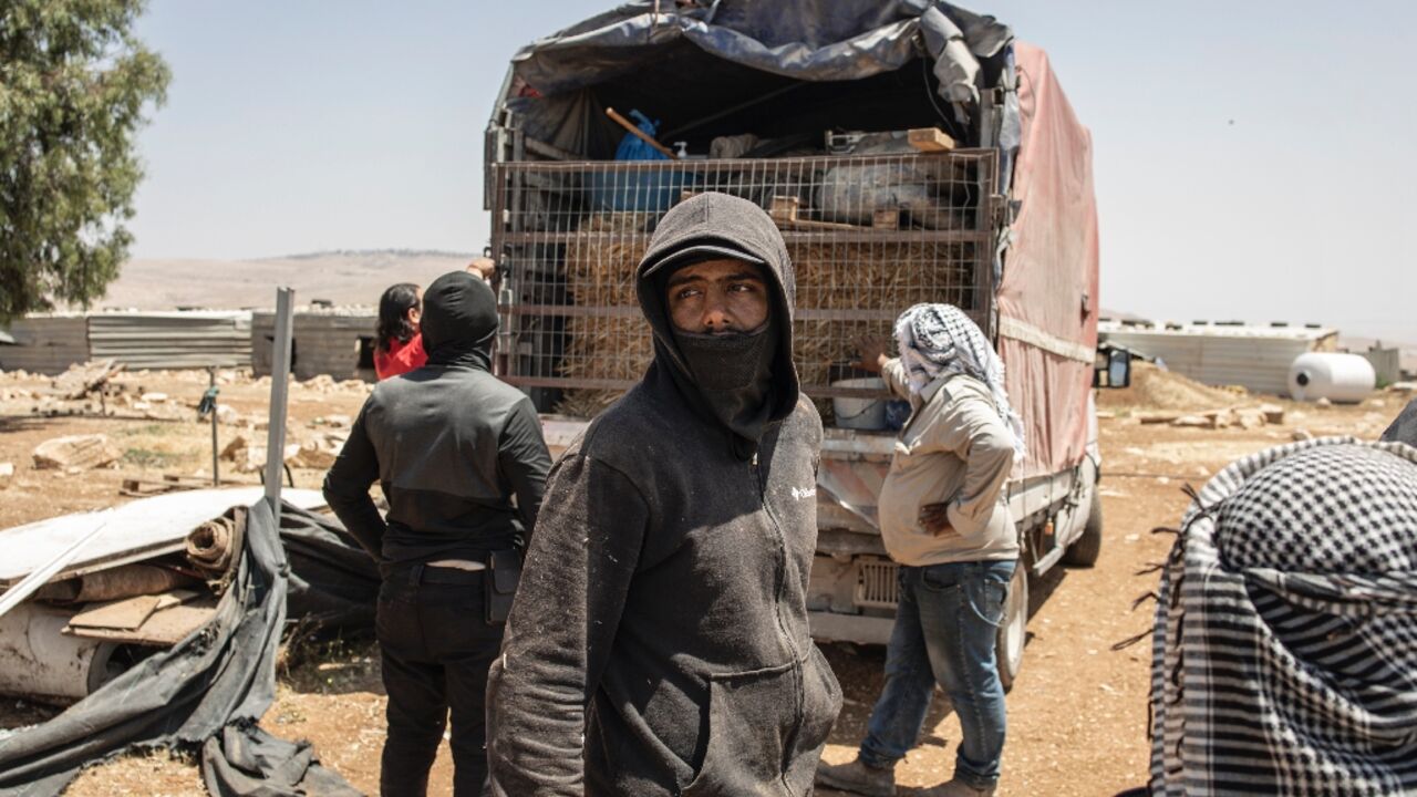 Men load a truck with their belongings in Maghayer al-Deir, east of Ramallah in the occupied West Bank Men load a truck with their belongings in Maghayer al-Deir, east of Ramallah in the occupied West Bank
