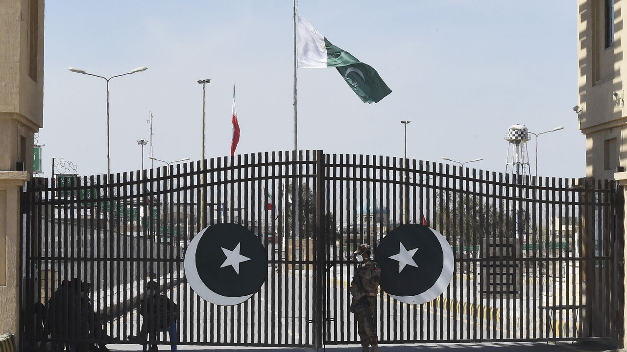 Pakistani soldiers wearing facemasks stand guard at the closed Pakistan-Iran border in Taftan on February 25, 2020 as fears over the spread of the COVID-19 coronavirus escalate following an outbreak in neighbouring Iran. - The Iranian outbreak where at least 15 people have already died -- the highest death toll in any country outside of China -- has aggravated already frayed nerves in neighbouring Afghanistan and Pakistan. (Photo by Banaras KHAN / AFP) (Photo by BANARAS KHAN/AFP via Getty Images)
