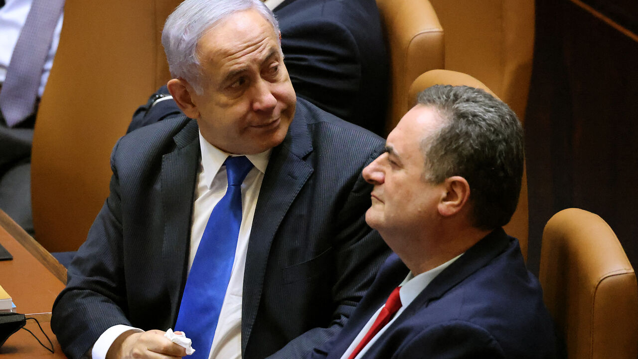 Israeli prime minister Benjamin Netanyahu (L), accompanied by outgoing finance minister Yisrael Katz, on June 13, 2021.