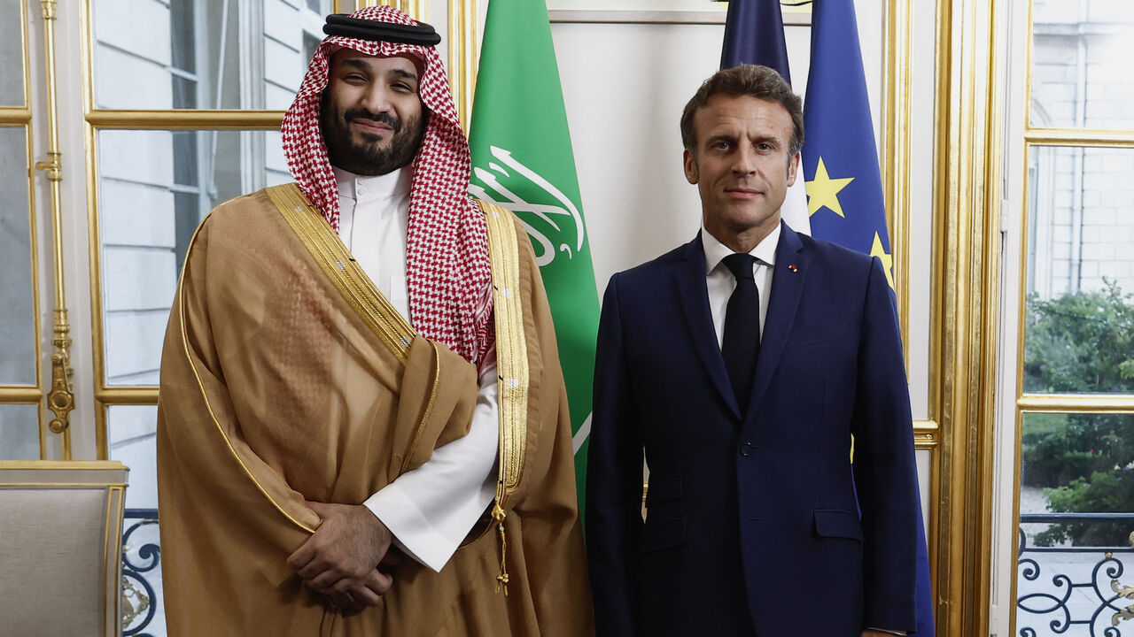France's President Emmanuel Macron (R) poses with Saudi Crown Prince Mohammed bin Salman upon his arrival at presidential Elysee Palace in Paris on July 28, 2022. (Photo by BENOIT TESSIER/POOL/AFP via Getty Images)