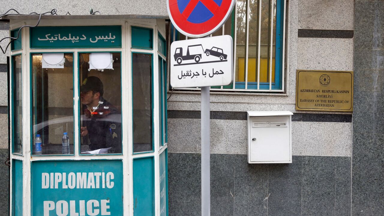 A policeman guards the entrance of the Azerbaijan Embassy in Tehran on Jan. 27, 2023, following an attack.