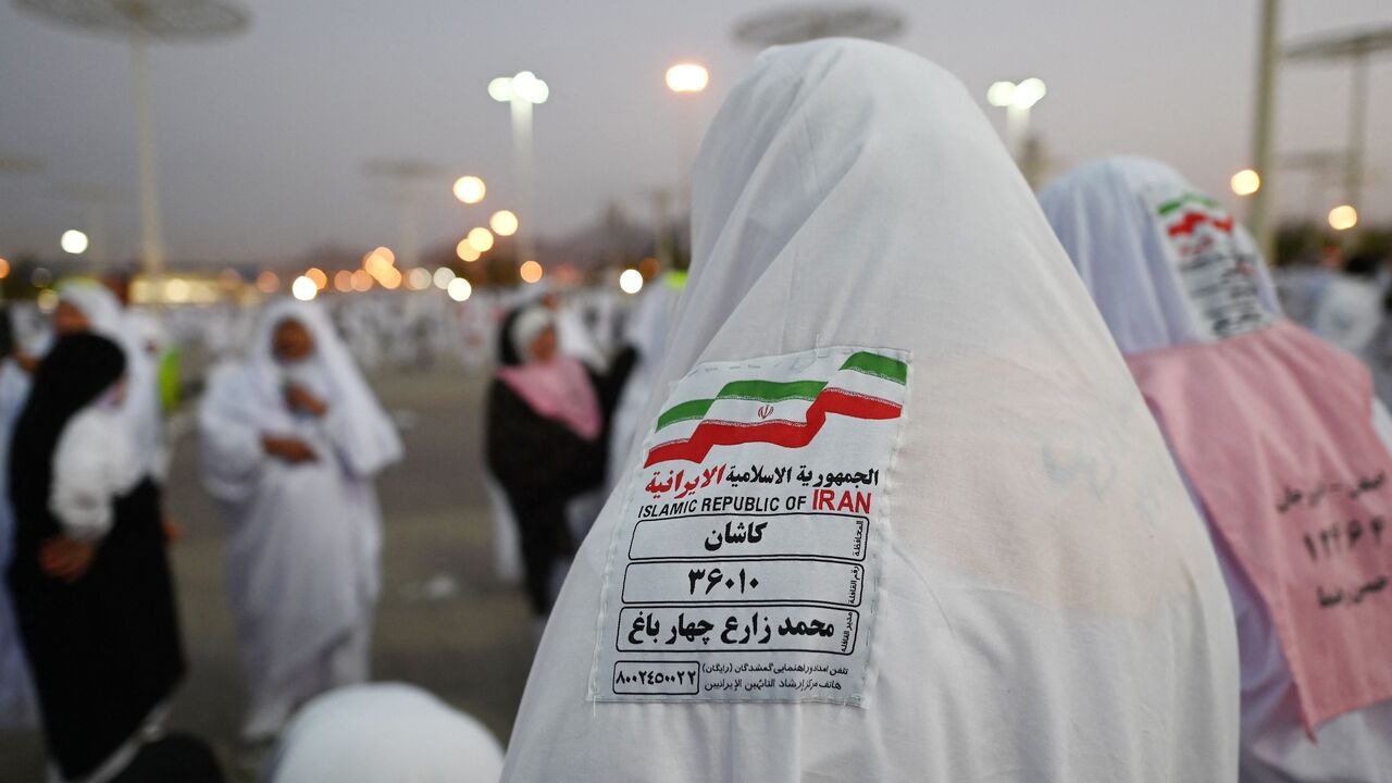 Iranian Muslim pilgrims head to Saudi Arabia's Mount Arafat, also known as Jabal al-Rahma or Mount of Mercy, during the climax of the Hajj pilgrimage, on June 27, 2023.