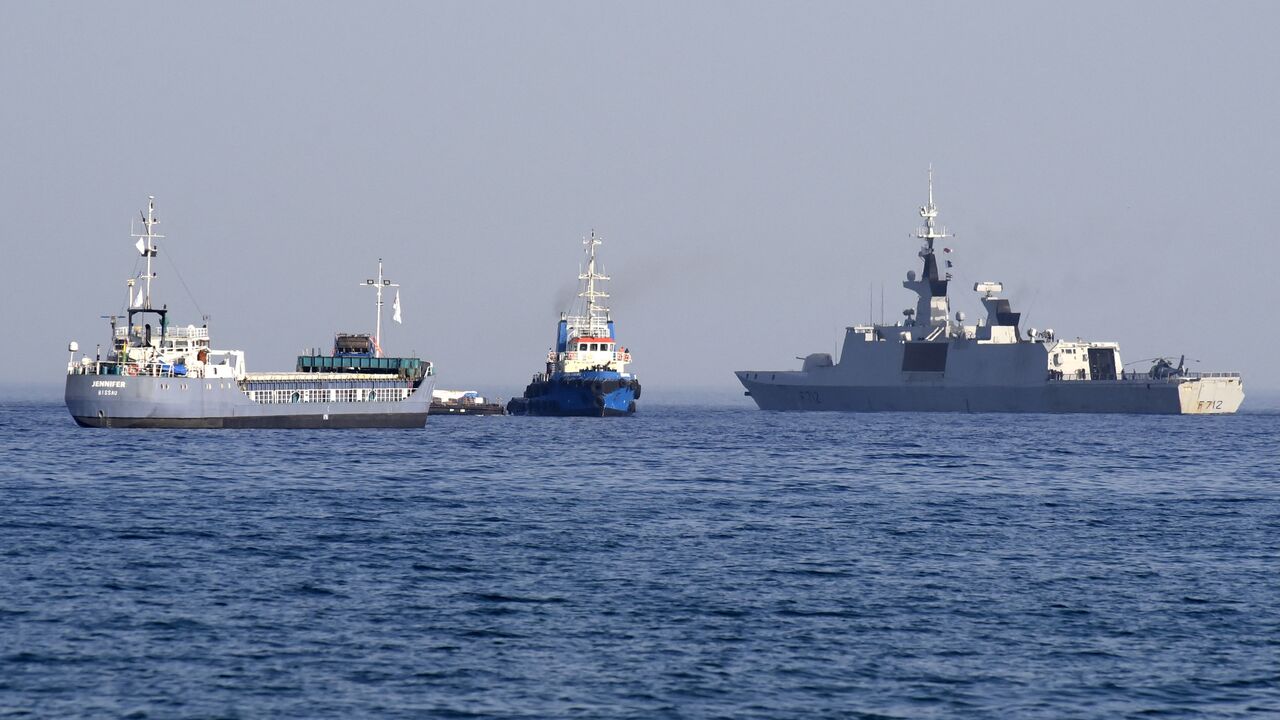 The barge Jennifer, part of a three ship flotilla carrying food aid for the Gaza Strip, sails next to the French frigate Courbet as the flotilla departs the port of Larnaca in Cyprus, March 30, 2024.