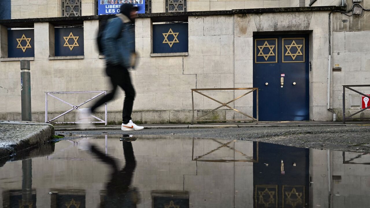 A man walks by the synagogue of Rouen, in northwestern France, on Jan. 7, 2025, following the discovery of an antisemitic graffiti.