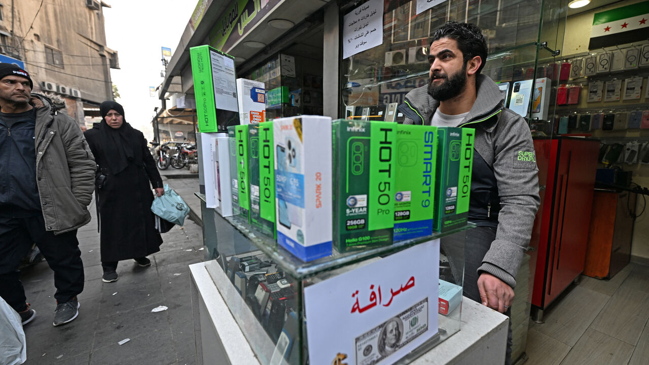 A vendor waits for customers at his mobile shop in the Damascus Tower market, which specializes in the smart phone business, in the Syrian capital on Jan. 12, 2025.