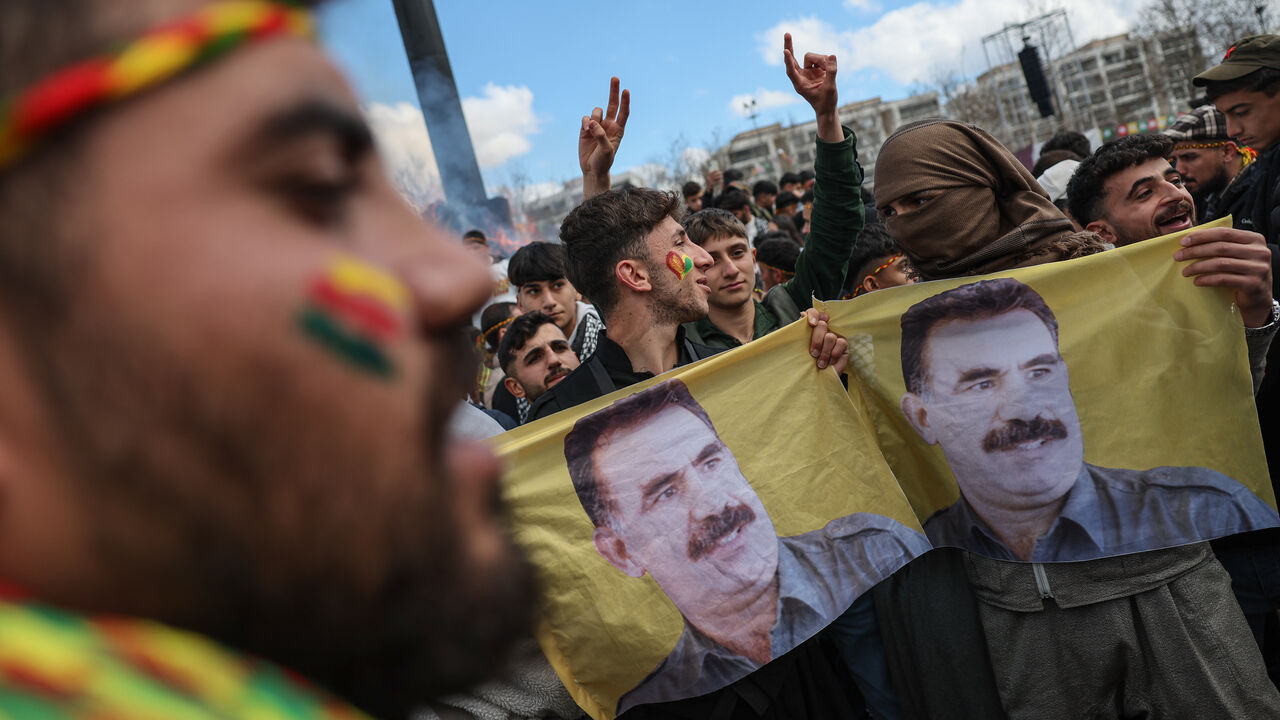 Kurdish youths holds a poster of jailed PKK militant group leader Abdullah Ocalan during Newroz celebrations on March 21, 2025 in Diyarbakir, Turkey.