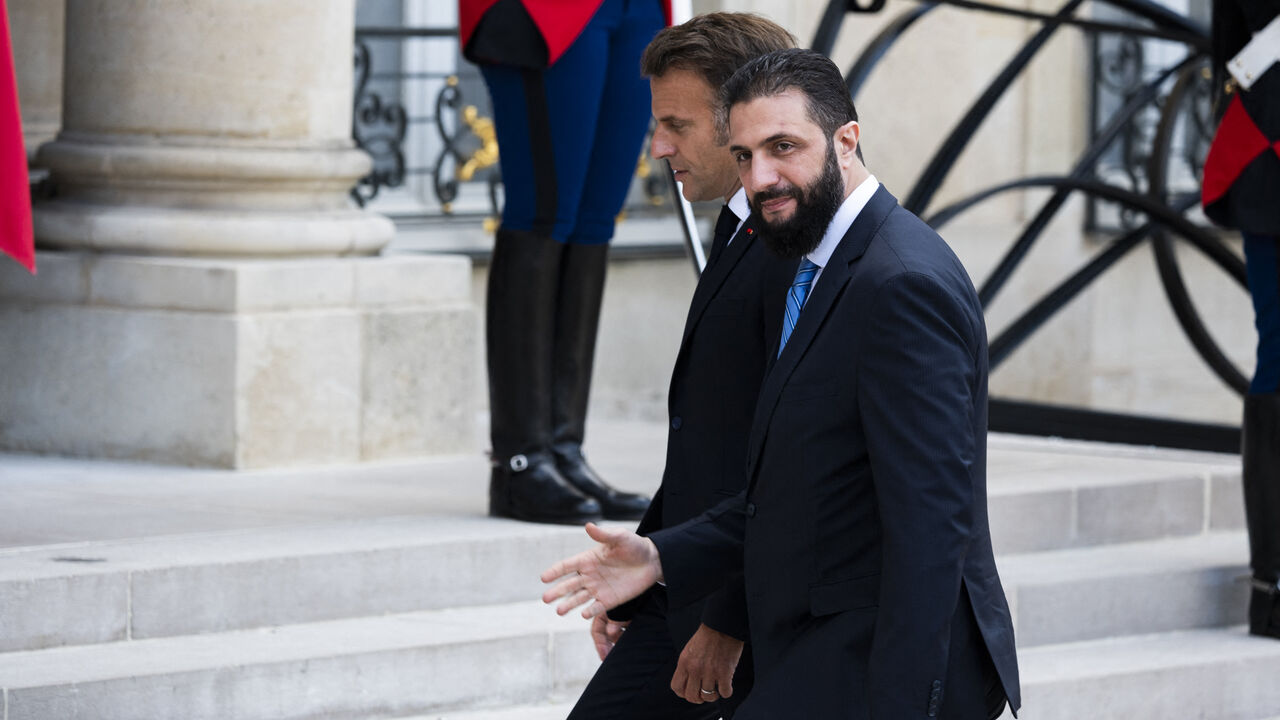 France s President Emmanuel Macron (R) welcomes Syrian interim President Ahmed al-Sharaa upon his arrival for their meeting at the Elysee presidential palace in Paris on May 7, 2025. Syrian interim President Ahmed al-Sharaa arrived in Paris on May 7, state media reported, on his first visit to Europe since overthrowing longtime ruler Bashar al-Assad in December. (Photo by Magali Cohen / Hans Lucas / Hans Lucas via AFP) (Photo by MAGALI COHEN/Hans Lucas/AFP via Getty Images)