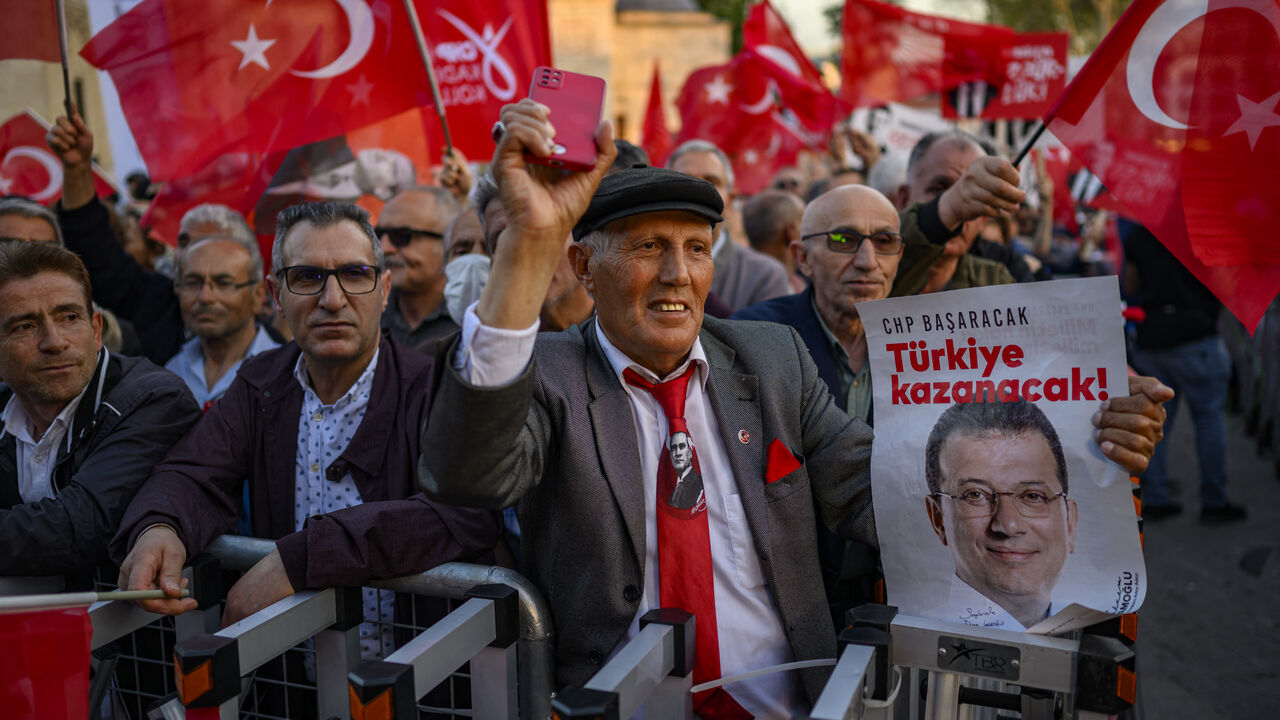 People hold Turkish flags and placards reading "winner Turkey" as they take part in a demonstration against the detention of the Mayor of Istanbul, Ekrem Imamoglu, organized by the country's main opposition, the Republican People's Party (CHP), at Beyazid Square, in Istanbul, May 7, 2025.