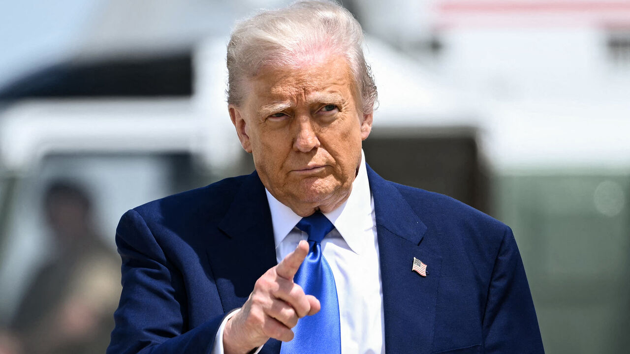 US President Donald Trump gestures as he walks to board Air Force One at Joint Base Andrews in Maryland, May 12, 2025.