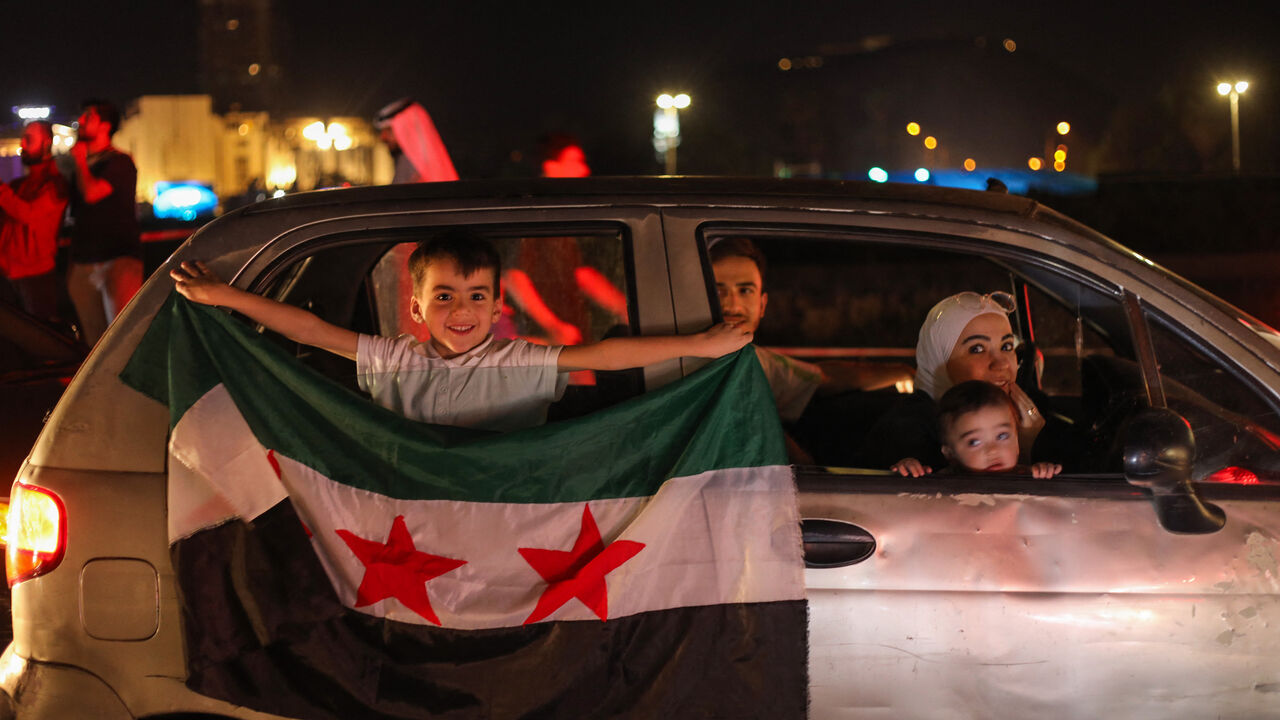 People celebrate in Damascus' Omeyyad square after US President Donald Trump's decision to lift sanctions in Syria, on May 13, 2025. (Photo by Abdulaziz KETAZ / AFP) (Photo by ABDULAZIZ KETAZ/AFP via Getty Images)