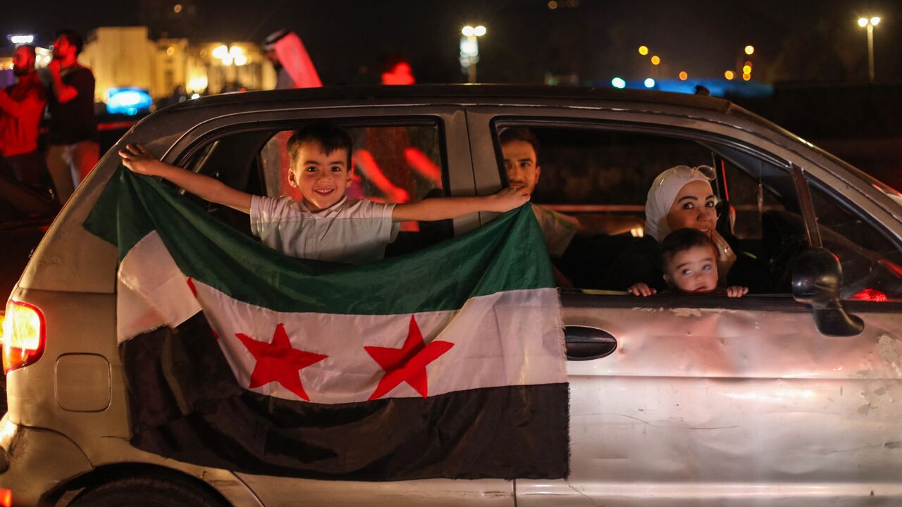 People celebrate in Damascus' Omeyyad Square after US President Donald Trump's decision to lift sanctions in Syria, on May 13, 2025.
