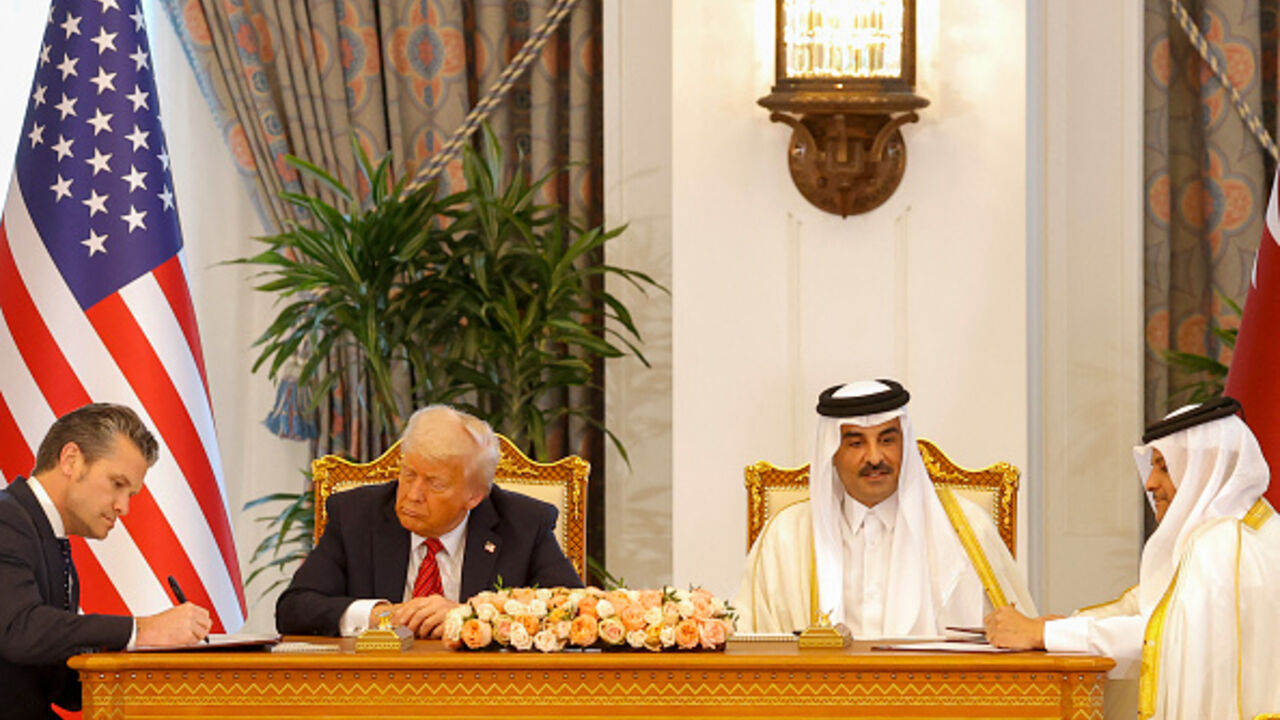 QATAR-US-DIPLOMACY Qatar's Emir Sheikh Tamim bin Hamad al-Thani (C-R) and US President Donald Trump (C-L) watch as US Secretary of Defense Pete Hegseth (L) and Qatar's Deputy Prime Minister and Minister of State for Defence Affairs Sheikh Saoud bin Abdulrahman Al-Thani (R) sign documents during a signing ceremony at the Royal Palace in Doha on May 14, 2025. (Photo by Karim JAAFAR / AFP) (Photo by KARIM JAAFAR/AFP via Getty Images)
