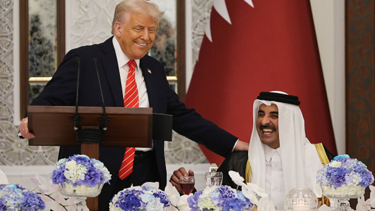 U.S. President Donald J. Trump jokes with Emir of Qatar Tamim bin Hamad al Thani as they attend a state dinner at the Lusail Palace on May 14, 2025, in Doha, Qatar. The visit underscores the strategic partnership between the United States and Qatar, focusing on regional security and economic collaboration.