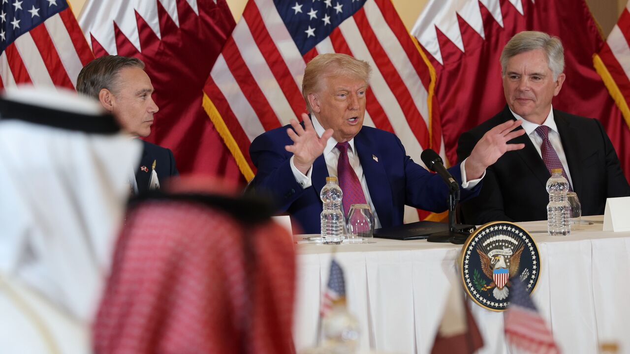 US President Donald J. Trump, flanked by chairman and CEO of GE Aerospace Larry Culp (R) and CEO of Boeing Kelly Ortberg (L), meets with business leaders at the Ritz Carlton Hotel, Doha, Qatar, May 15, 2025.