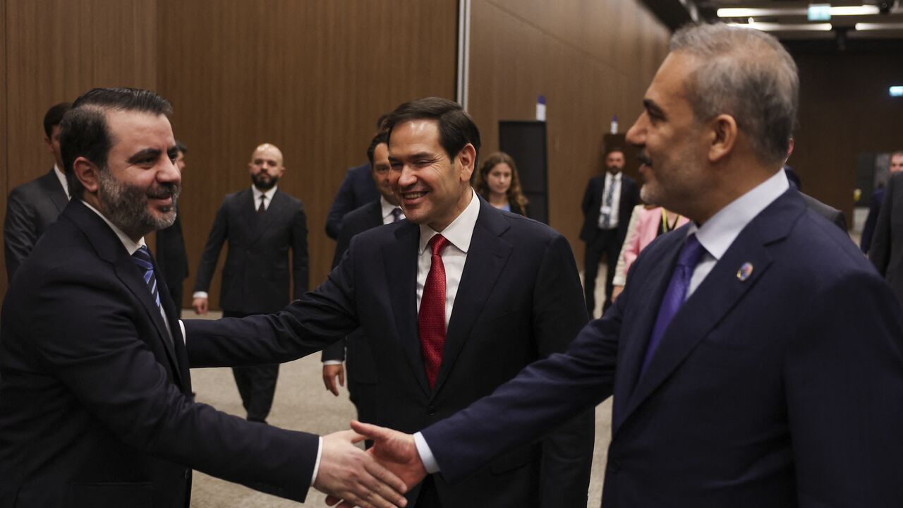 Turkish Foreign Minister Hakan Fidan (R) shakes hands with Syrian Foreign Minister Asaad Hassan al-Shaibani, and US Secretary of State Marco Rubio (C) reacts.