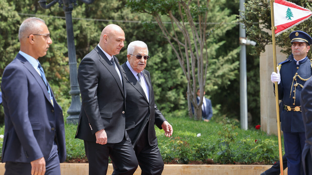 Lebanese President Joseph Aoun (2nd L) walks alongside Palestinian Authority President Mahmud Abbas as they review an honour guard at the Presidential Palace in Baabda, on May 21, 2025.