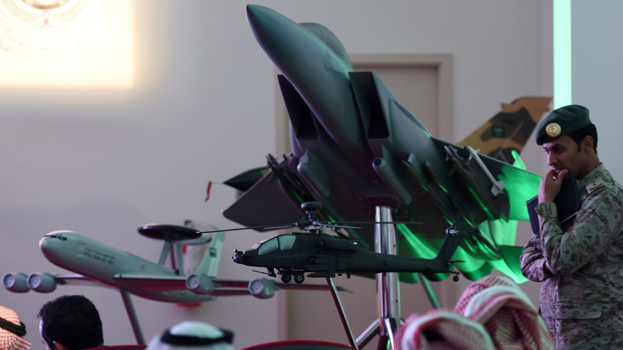 A member of Saudi security forces stands next to a replica of a fighter jet of the Saudi armed forces during the daily media briefing on Operation Decisive Storm, the Saudi-led coalition carrying out air strikes against Shiite Huthi militia in neighboring Yemen, on April 2, 2015 at the Air Base of the Saudi capital Riyadh.