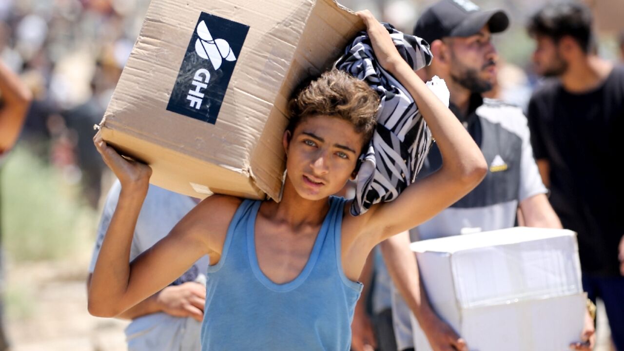A boy carries a box of supplies from the Gaza Humanitarian Foundation, a private US-backed aid group that has bypassed the longstanding UN-led system A boy carries a box of supplies from the Gaza Humanitarian Foundation, a private US-backed aid group that has bypassed the longstanding UN-led system
