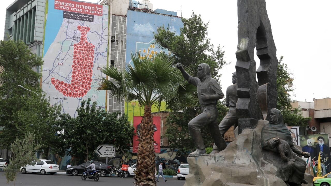 People drive past an anti-Israel billboard in Tehran's Palestine square on May 5, 2025 People drive past an anti-Israel billboard in Tehran's Palestine square on May 5, 2025