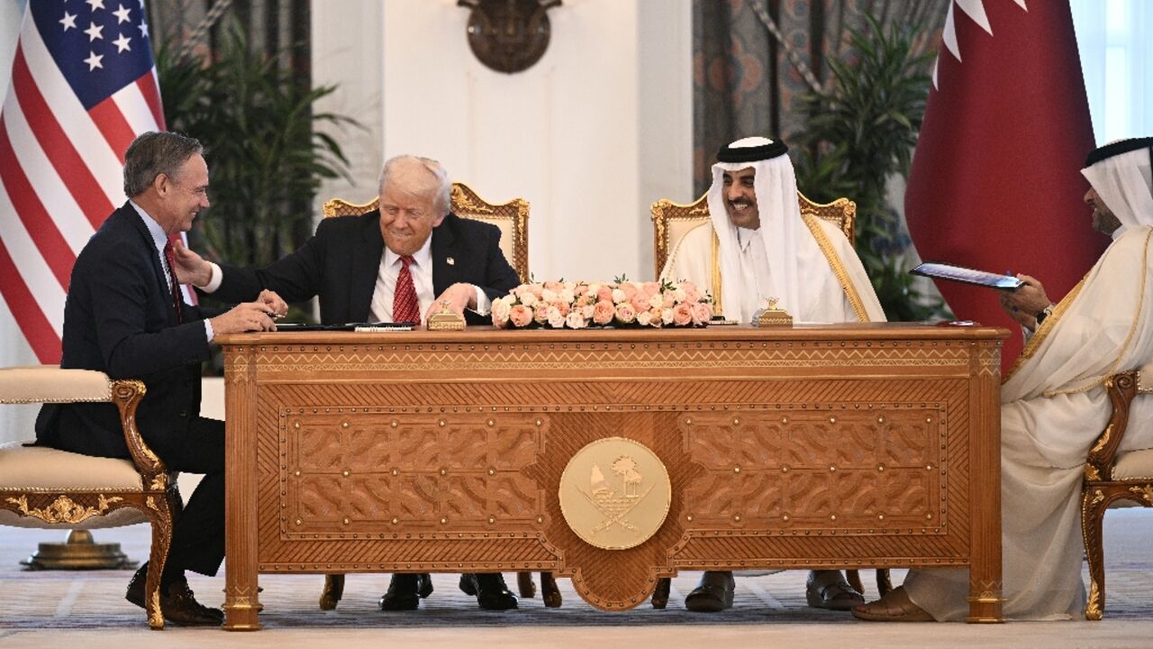 Boeing CEO Kelly Ortberg sits to the left of US President Donald Trump and Qatar's Emir Sheikh Tamim bin Hamad al-Thani (R) during a business deal signing ceremony at the Royal Palace in Doha, on May 14, 2025 Boeing CEO Kelly Ortberg sits to the left of US President Donald Trump and Qatar's Emir Sheikh Tamim bin Hamad al-Thani (R) during a business deal signing ceremony at the Royal Palace in Doha, on May 14, 2025