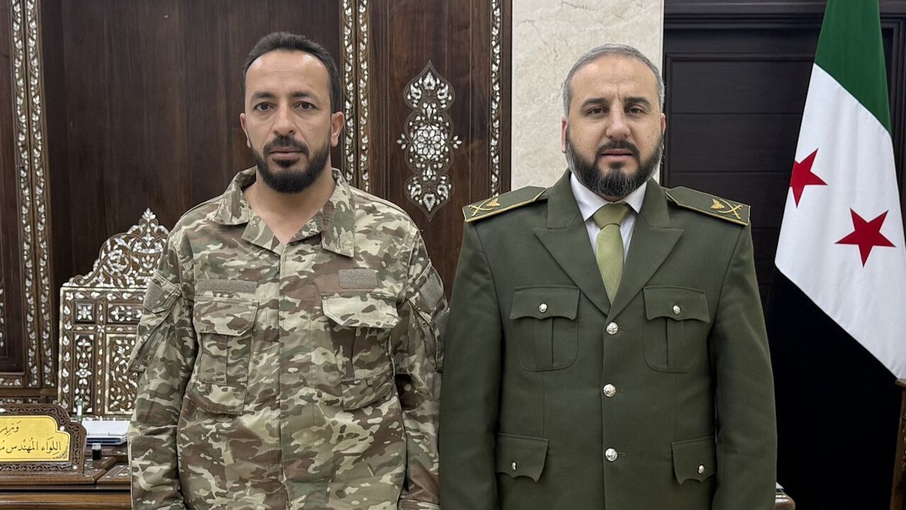 Ahmad al-Hayes (L) is seen with interim Syrian Defense Minister Murhaf Abu Qasra. — X