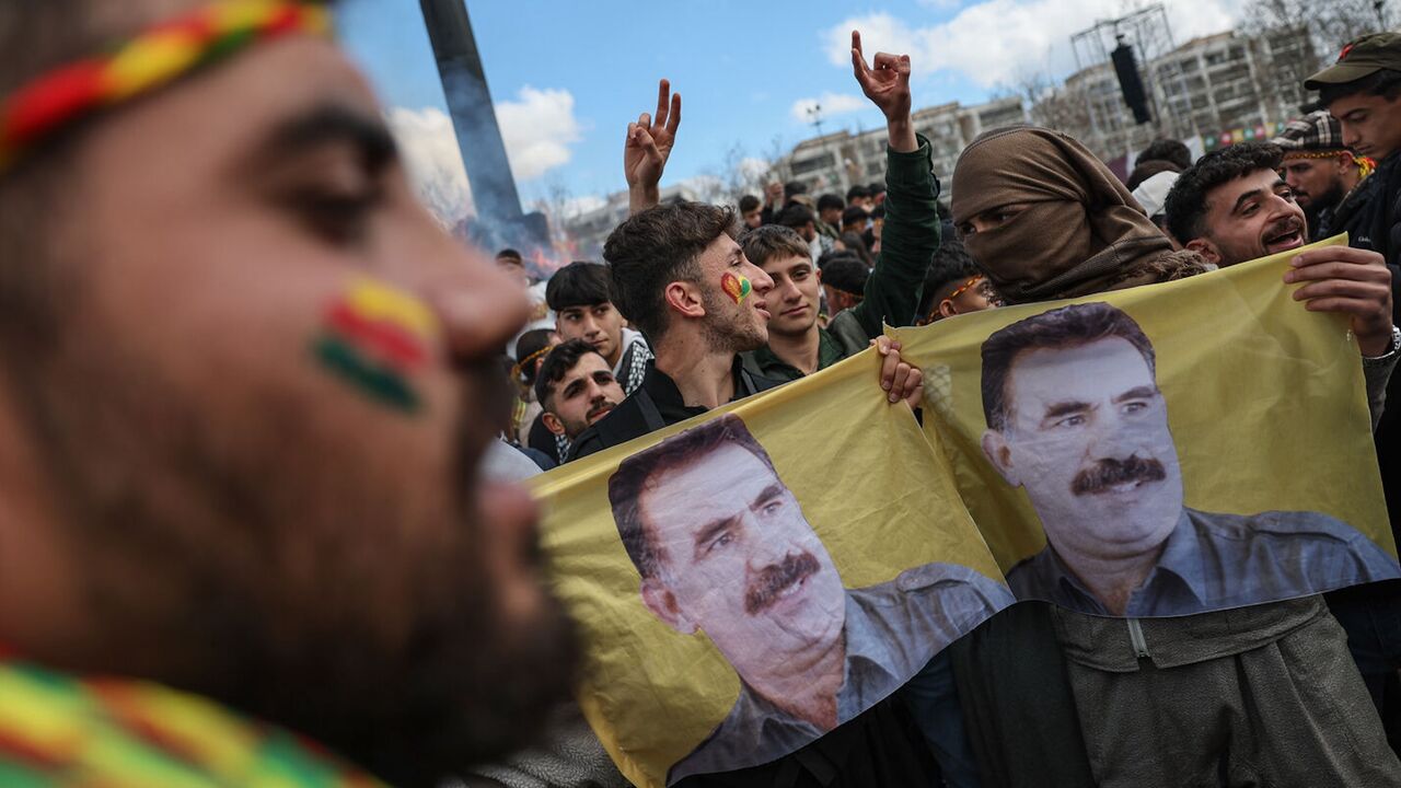 Kurdish youths holds a poster of jailed PKK militant group leader Abdullah Ocalan during Newroz celebrations, on March 21, 2025, in Diyarbakir, Turkey.